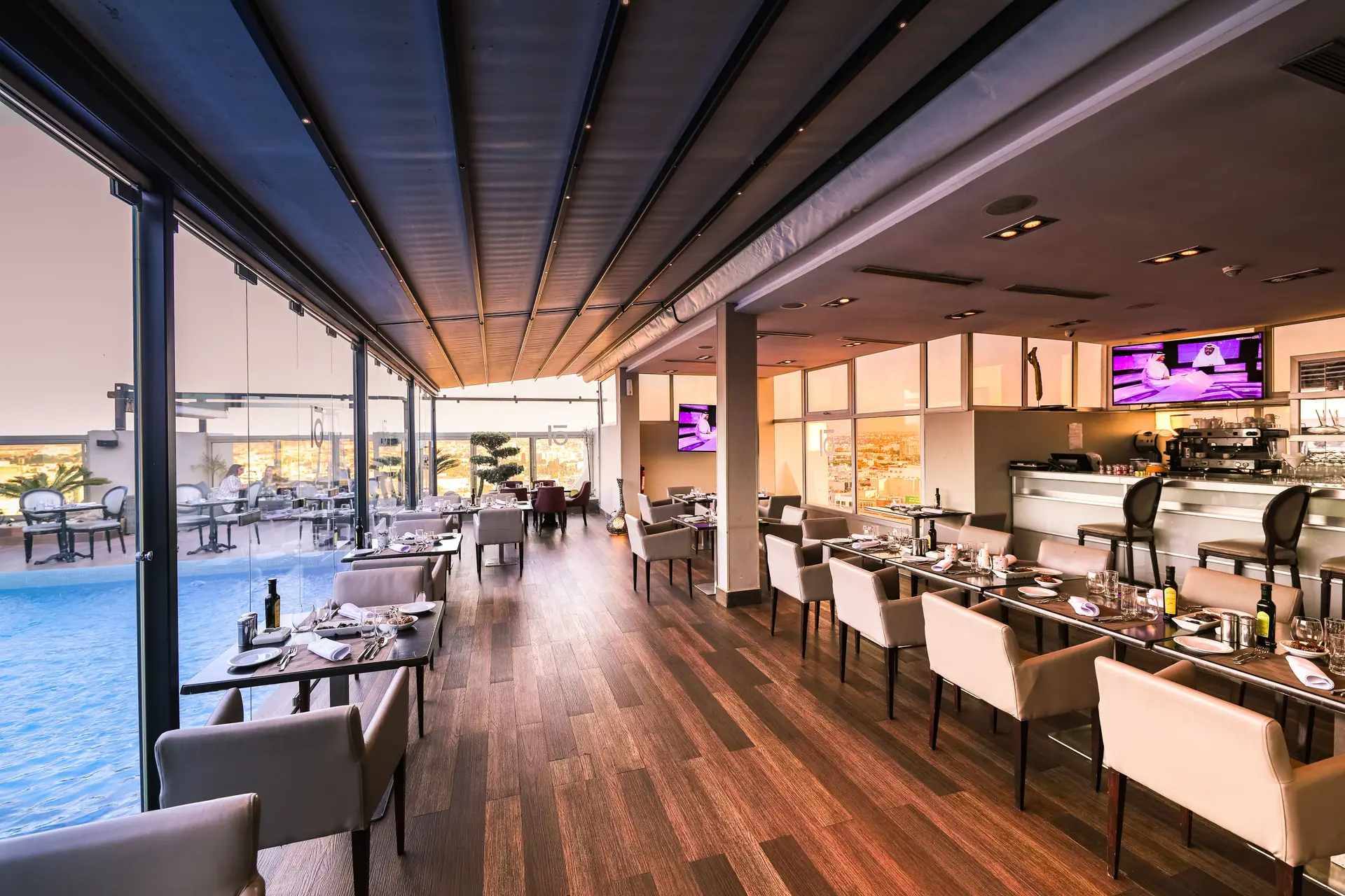 Sophisticated dining interior at MirevellangrandHaven overlooking a serene pool
